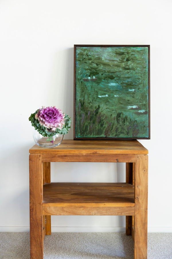 A tranquil landscape painting titled "The Quiet After The Rain" by Marisabel Gonzalez, featuring a peaceful scene with soft colors.